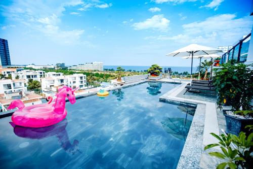 a pool with a pink float in the water at Galvin Hotel in Sầm Sơn