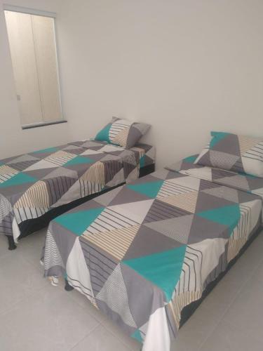 A bed or beds in a room at Pousada Parque das Águas