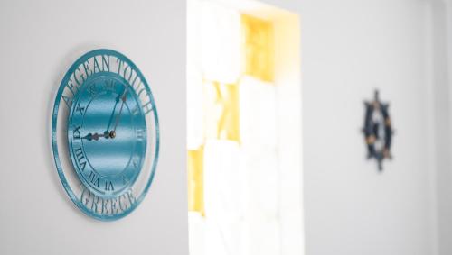 a round mirror on a wall next to a door at Aegean Touch Beach House in Artemida