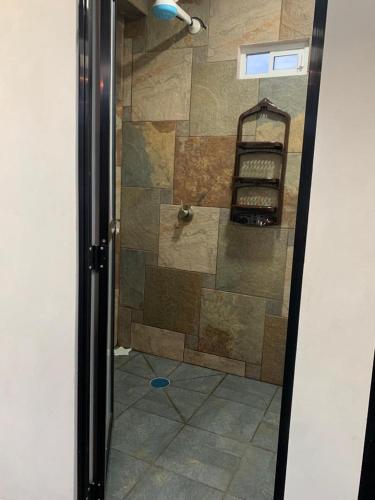 a shower in a bathroom with a glass door at verde amanecer in Xilitla