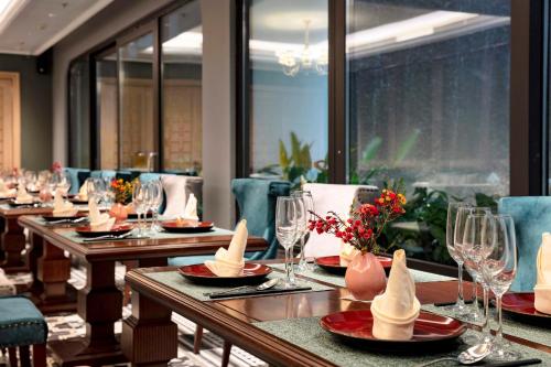 a row of tables in a restaurant with food on them at Peridot Grand Luxury Boutique Hotel in Hanoi