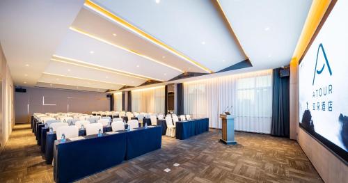 a conference room with rows of chairs and a podium at Atour Hotel Shenyang Changbai Island in Shenyang