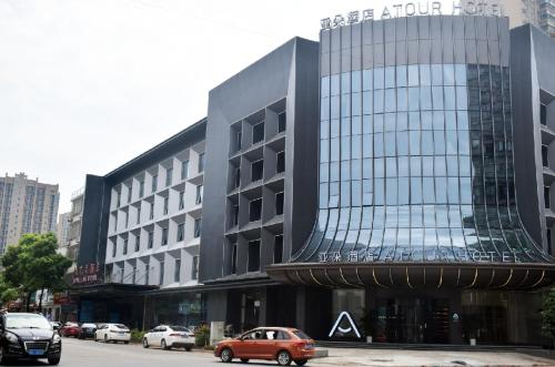 a car is parked in front of a building at Atour Hotel Changsha Wangcheng District in Changsha