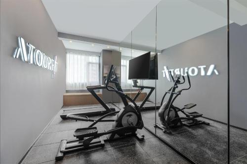 a gym with two exercise bikes and a television at Atour Hotel Xishuangbanna Jinghong Gaozhuang Starlight Night Market in Jinghong
