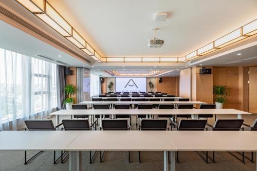 a large room with tables and chairs in it at Atour Changsha Xingsha in Changsha