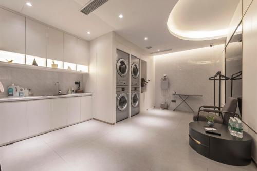 a living room with three washer and dryer at Atour Light Hotel Chengdu Dujiangyan in Dujiangyan