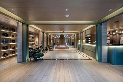 a long hallway with a room with wine bottles at Atour Hotel Shanghai World Expo West Gaoke Road in Shanghai