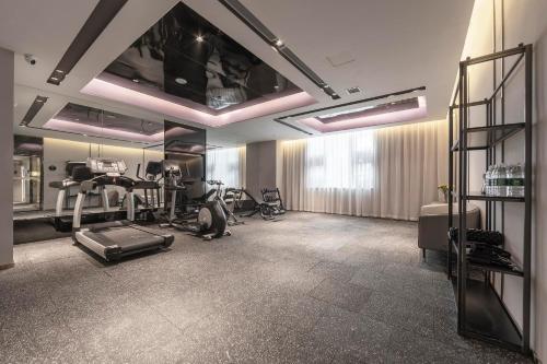 a gym with treadmills and exercise equipment in a room at Atour Light Hotel Chengdu Dujiangyan in Dujiangyan