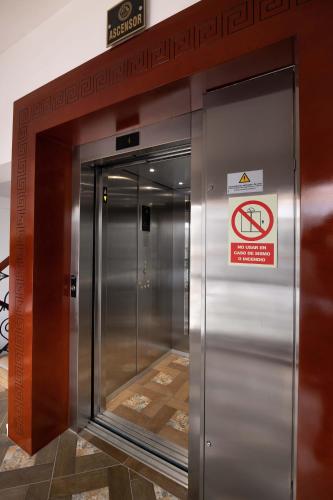an elevator in a building with a sign on it at Hotel Hacienda Cusco Centro Historico in Cusco