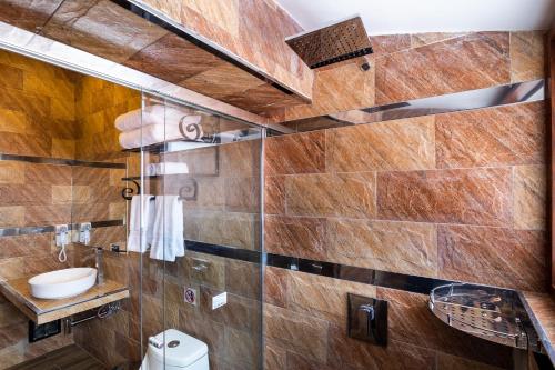 a bathroom with a toilet and a sink at Hotel Hacienda Cusco Centro Historico in Cusco