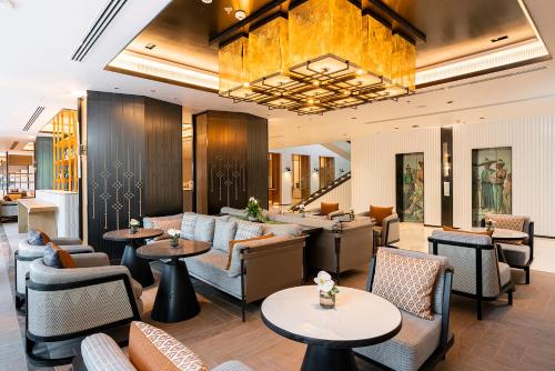 a hotel lobby with couches and tables at Melia Chiang Mai in Chiang Mai