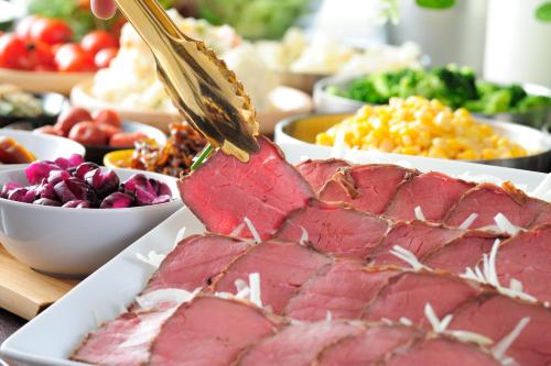 a table topped with meat and bowls of different foods at Centurion Hotel&Spa Vintage Kobe in Kobe