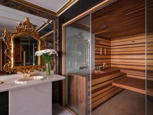 a bathroom with two sinks and a mirror at Rixos Khadisha Shymkent in Shymkent