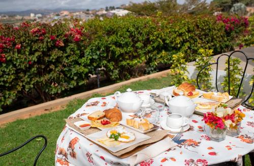 a table with a plate of bread and tea on it at Somptua Garden in Ivato
