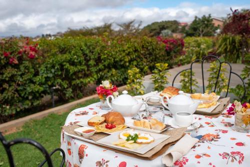 a table with a plate of bread and tea on it at Somptua Garden in Ivato