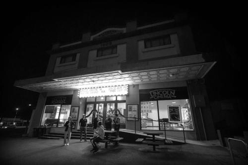 a group of people in front of a building at night at Tasman Beachside Apartment in Port Lincoln