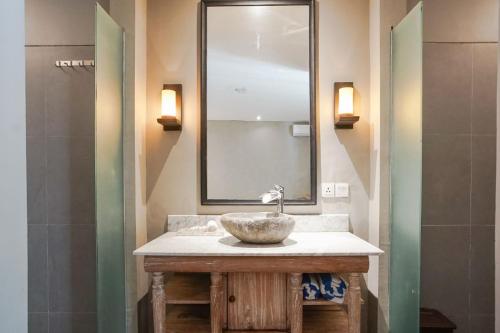 a bathroom with a sink and a mirror at Villa Bima II in Nusa Dua
