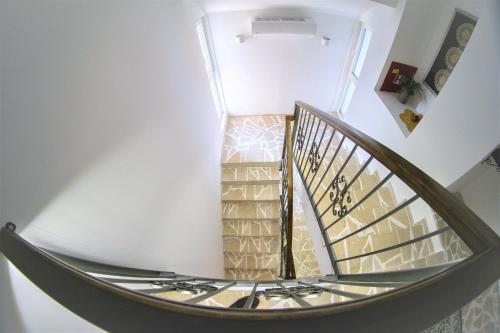 a spiral staircase in a home with a stair case at Herceg Vila in Trebinje