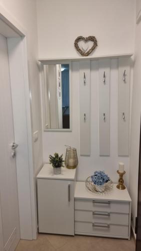 a dressing room with white cabinets and a mirror at Two stars - Villa Sunce in Senj