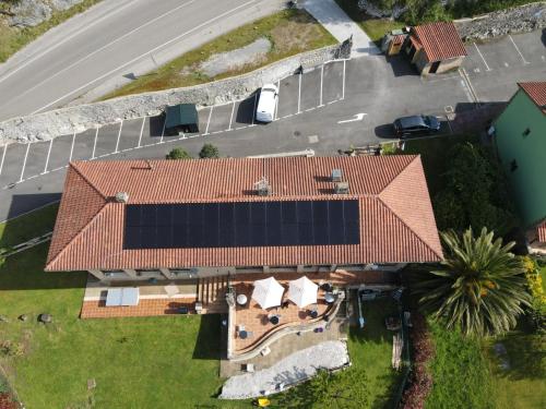 an overhead view of a house with a solar roof at Prau Riu Hotel Hyundai-Asturdai in Llanes