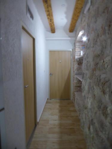 a hallway with a door and a stone wall at Apartaments Marko in Kotor