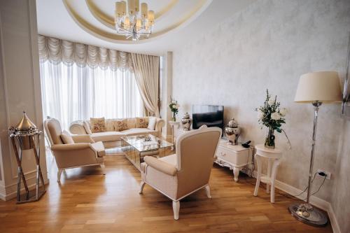 a living room with a couch and a table at Qafqaz Sahil Hotel Baku in Baku