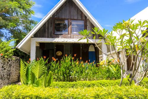 a house with a garden in front of it at Chanteak Bali in Jimbaran