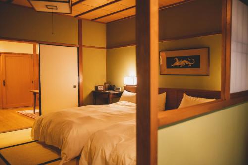 a bedroom with a bed in a room at Arima Onsen Tocen Goshobo in Kobe