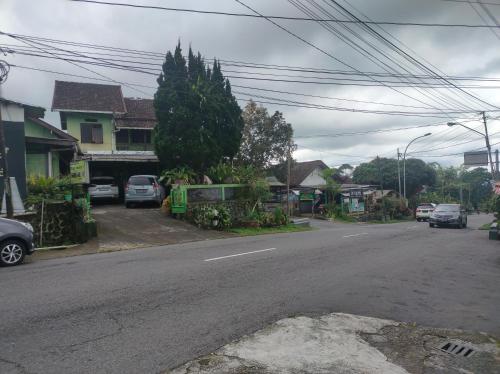 a street with cars parked on the side of the road at Bayu Murti Inn Kaliurang Yogyakarta RedPartner in Kaliurang