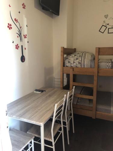 uma mesa e cadeiras num quarto com uma cama em Apartments Mikulić em Zadar