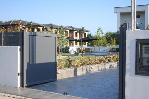 a gate in front of a house with a yard at Luxury Villa Plaka Litochorou with Pool in Plaka Litochorou