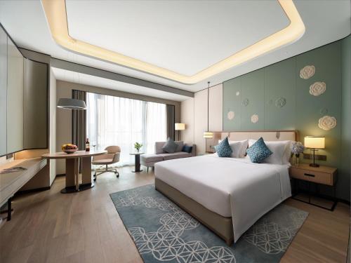 - une chambre avec un grand lit et un salon dans l'établissement 重庆金科大酒店, à Renhe