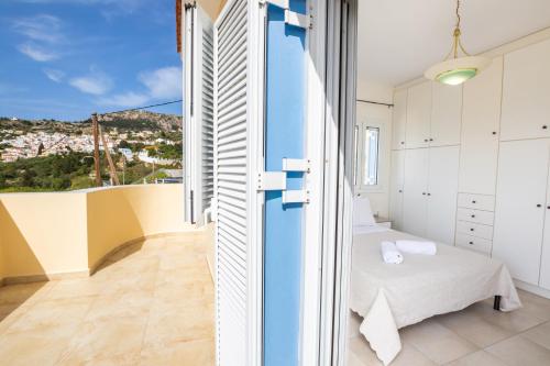 a room with two beds and a view of the city at Karpathos View Villa in Karpathos
