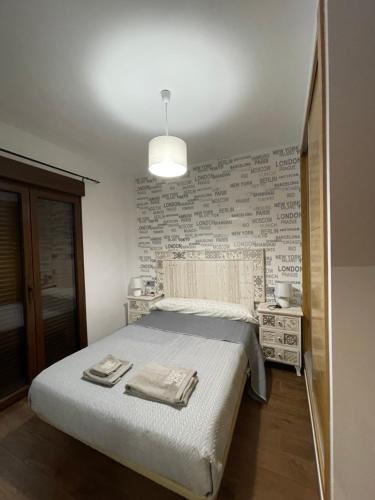 een slaapkamer met een groot bed en een hanglamp bij Calahondaplaya, provincia de Granada in Calahonda