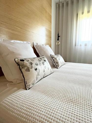 a bedroom with two beds with white pillows at Casa Das Chães in Caniçada