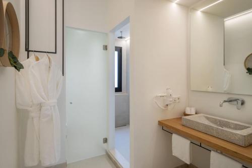 a white bathroom with a sink and a mirror at Can Vidal Boutique Rooms in Inca
