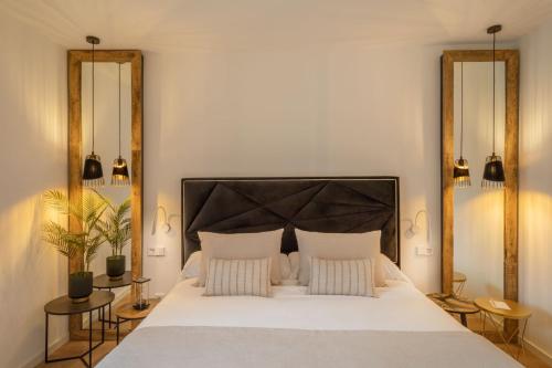 a bedroom with a large white bed with two pillows at Can Vidal Boutique Rooms in Inca