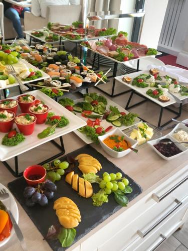 a buffet filled with lots of different types of food at Hudson in Koszalin