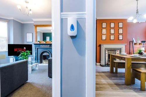 a living room and a dining room with a fireplace at Spacious Modern Chester Home - Great Location in Chester