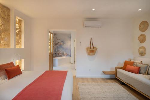 a bedroom with a bed and a couch at Can Vidal Boutique Rooms in Inca