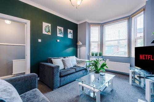 a living room with a couch and a tv at Spacious Modern Chester Home - Great Location in Chester