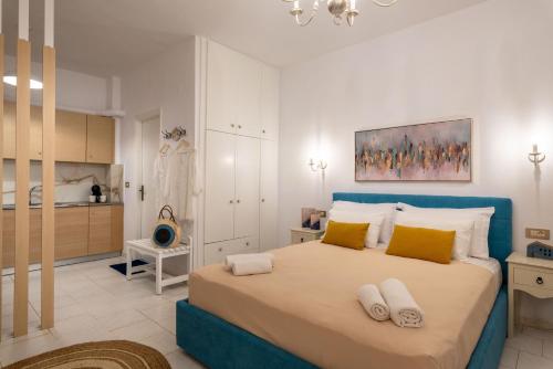 a bedroom with a large bed with yellow pillows at Esperides Studios in Syvota
