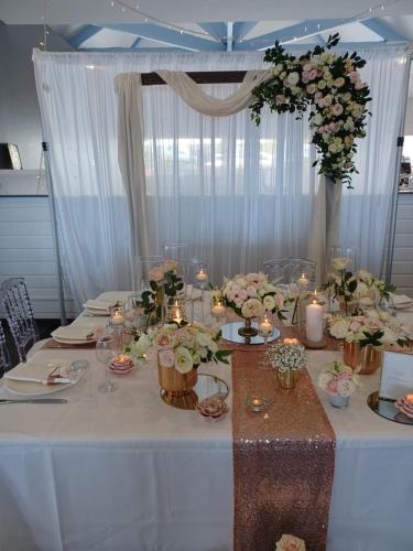 a long table with flowers and candles on it at Hôtel Les Embruns Du Baril in Basse Vallée