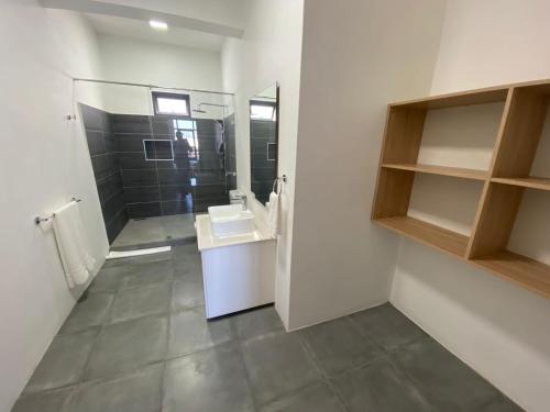 a bathroom with a toilet and a sink and a mirror at Dragon Nest Apartments in Port Louis