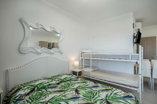 a bedroom with two bunk beds and a mirror at Planet Suite 504 in Bibione