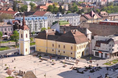 an old building with a clock tower in a city at Continental Forum Tirgu Mures in Târgu-Mureş