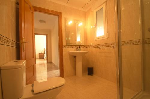a bathroom with a toilet and a sink and a shower at Villa Marhaba in Arboleas