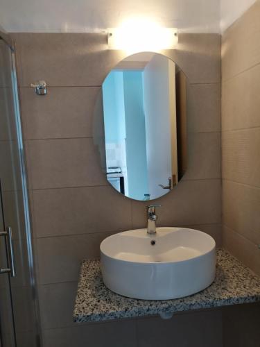a bathroom with a sink and a mirror at Giannis Studios in Alykes