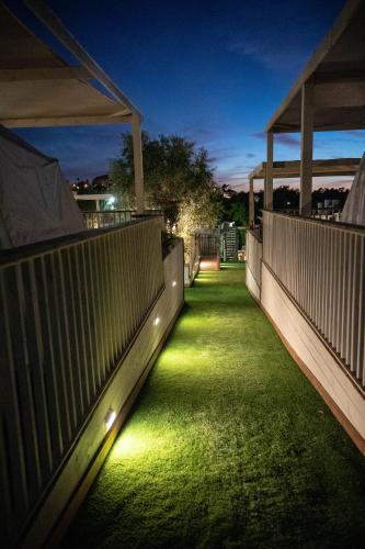 a walkway with lights on the side of a building at The Riders' Experience - Glamping and Attractions Park- Full Board in Bet Oren