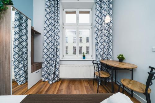 Postel nebo postele na pokoji v ubytování Grace Apartments